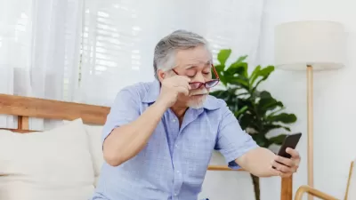 an image of a man looking at a phone