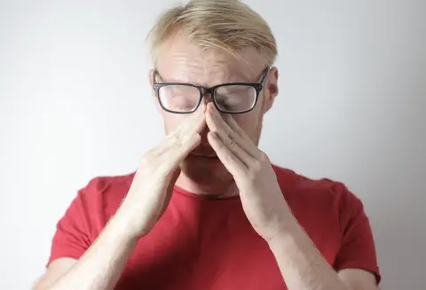 an image of a man experiencing digital eye strain