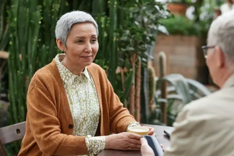 an image of two older adults talking