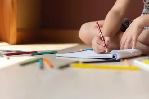 an image of a kid doing his workbook