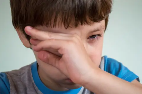 a photo of a child with eye discomfort