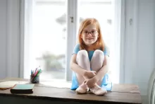 an image of a girl sitting by the window