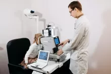 an image of a little girl doing eye testing