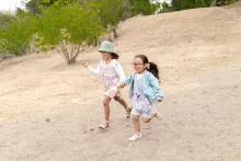 an image of two kids running outdoors