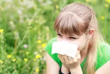a female sneezing in the field